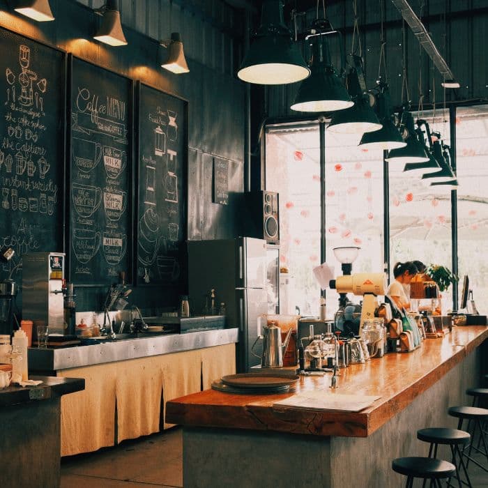Interior of a cozy coffee shop with barista serving customers