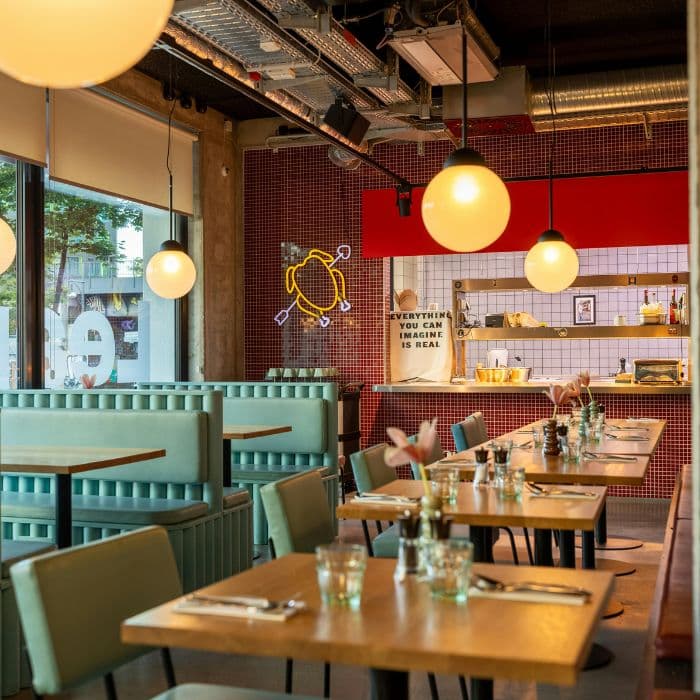 Interior of a cozy coffee shop with barista serving customers